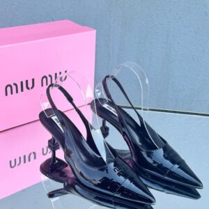 Miu Miu patent leather slingback pumps in black with a pointed toe and kitten heel